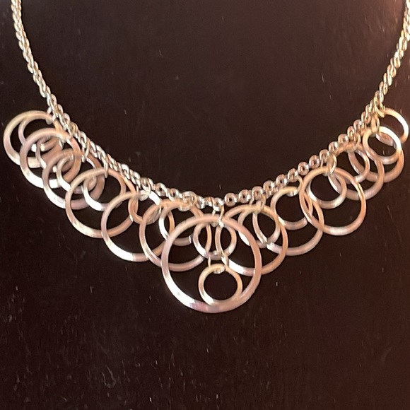 Light silver toned necklace with a variety of circles suspended on silver chain - Picture 4 of 13